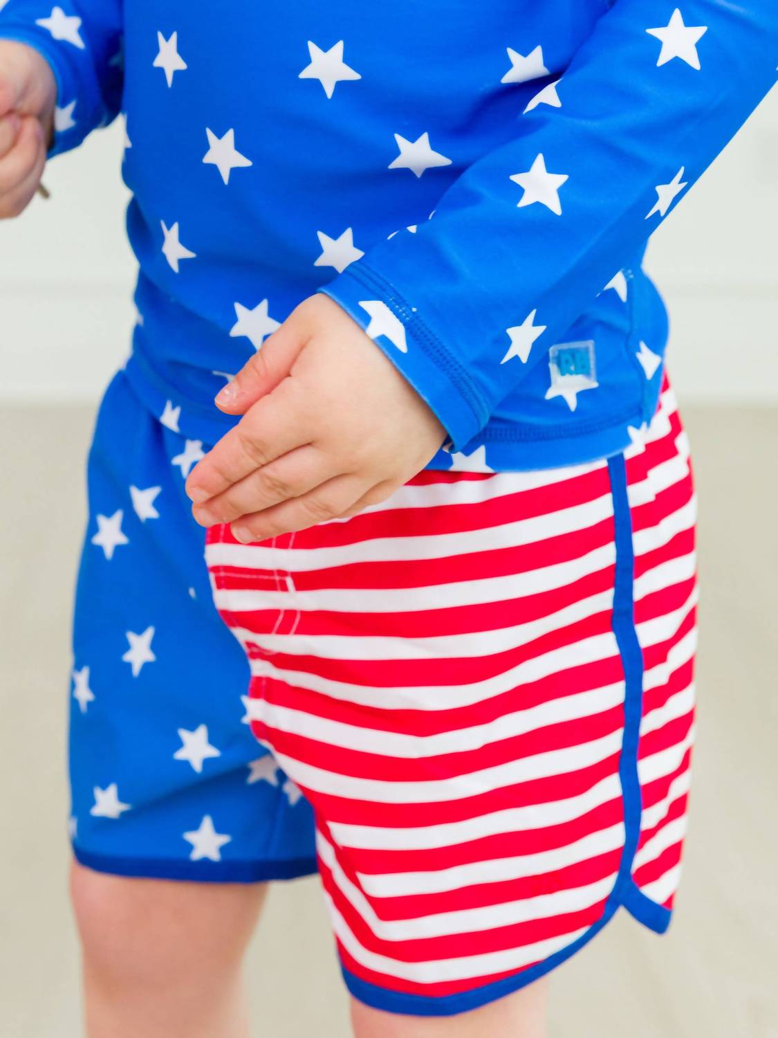 Rufflebutts - Boys Stars & Stripes Dolphin Hem Swim Trunks