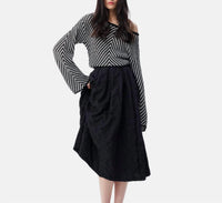 THEO the Label Calypso Plaid Box Pleat Midi Skirt in black - women's skirt