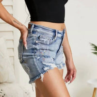 Judy Blue Mid-rise Rainbow Paint Splash Cut Off Shorts in blue - women's shorts - detail view