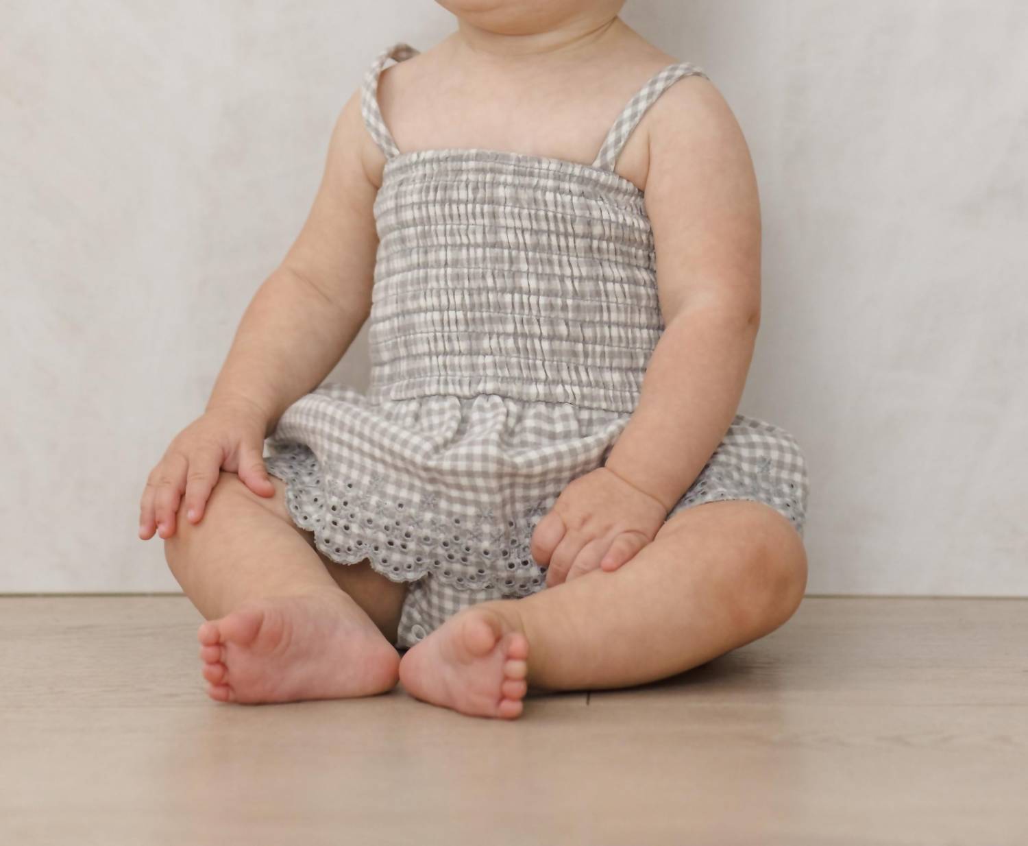 Quincy Mae Girls Smocked Skirted Romper in sage gingham - kids' item - detail view