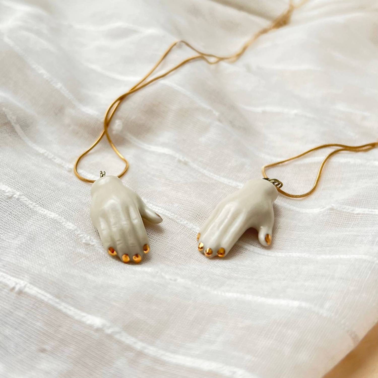 The Artifact House Women's Ceramic Hand Pendant Necklace in white and gold - women's jewelry