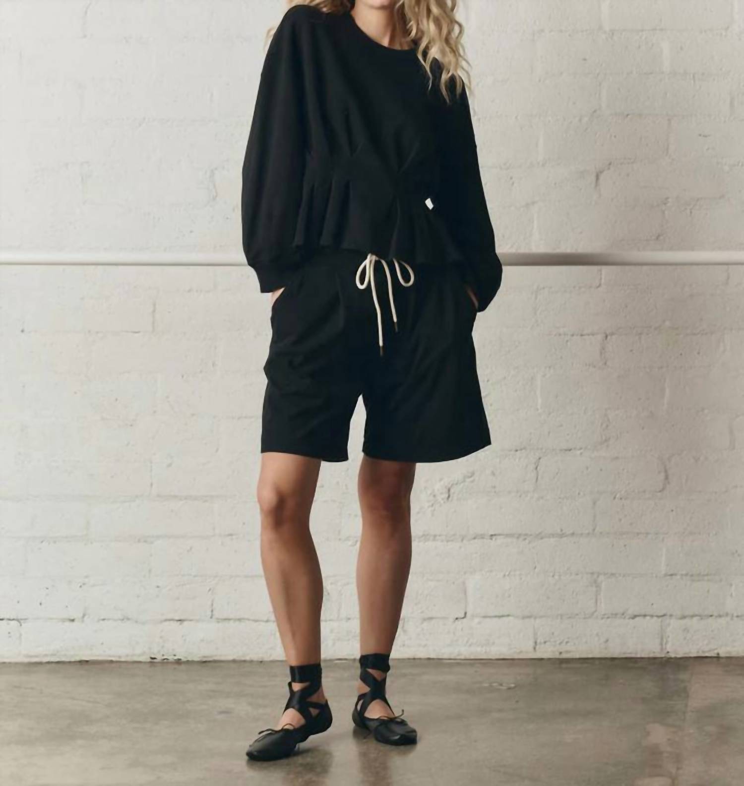 THE GREAT. The Slouchy Corset Sweatshirt in true black - women's top