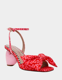 Betsey Johnson Women's Kendal Bow Novelty Heart-heel Sandal in red pink - women's heels