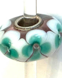 Trollbeads Women's Universal Charm Bead in unique light pink white with aqua flowers - women's item - detail view