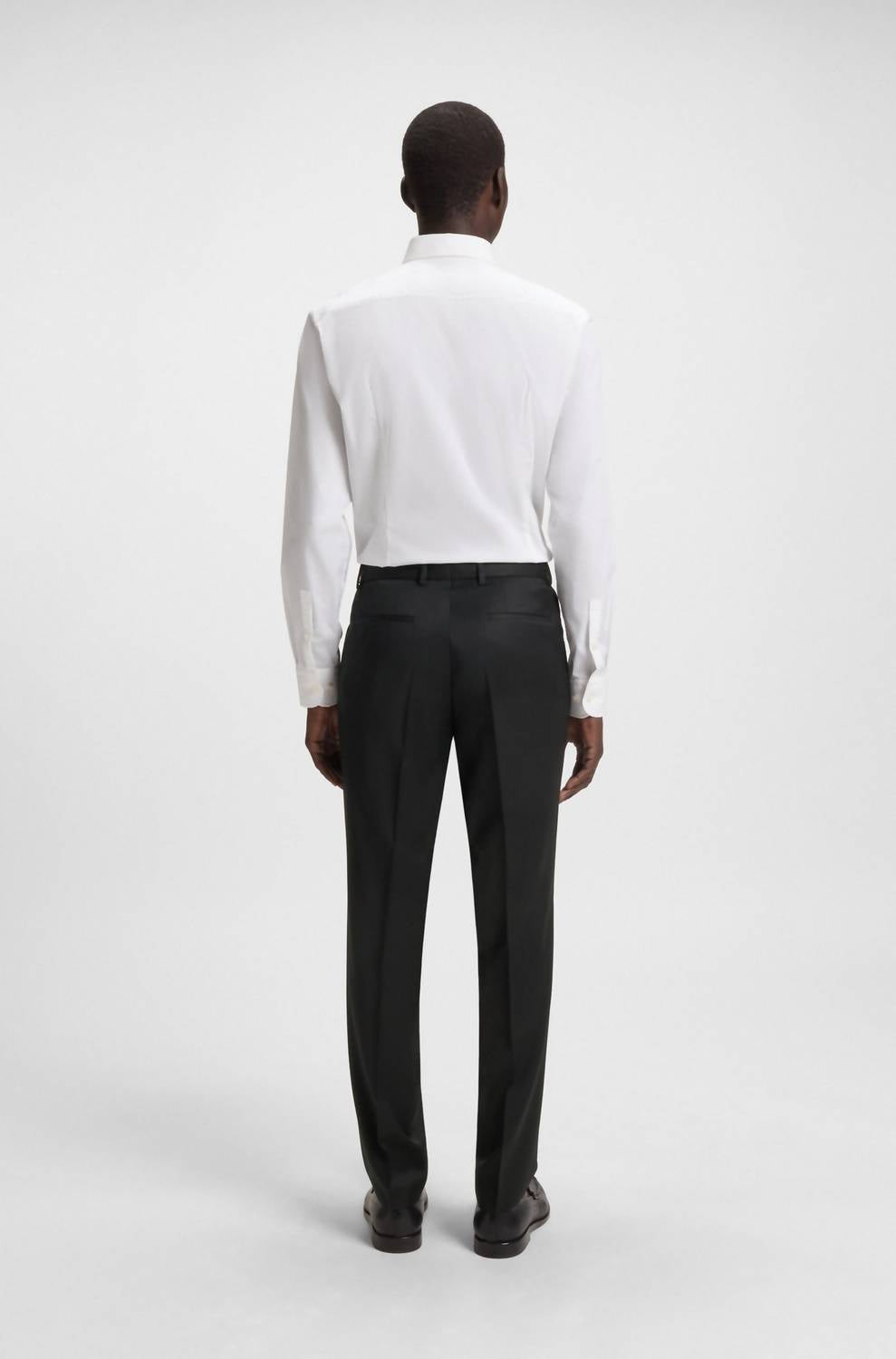 Hugo Boss Regular-fit Virgin-wool Serge Trousers in black - men's pants - detail view