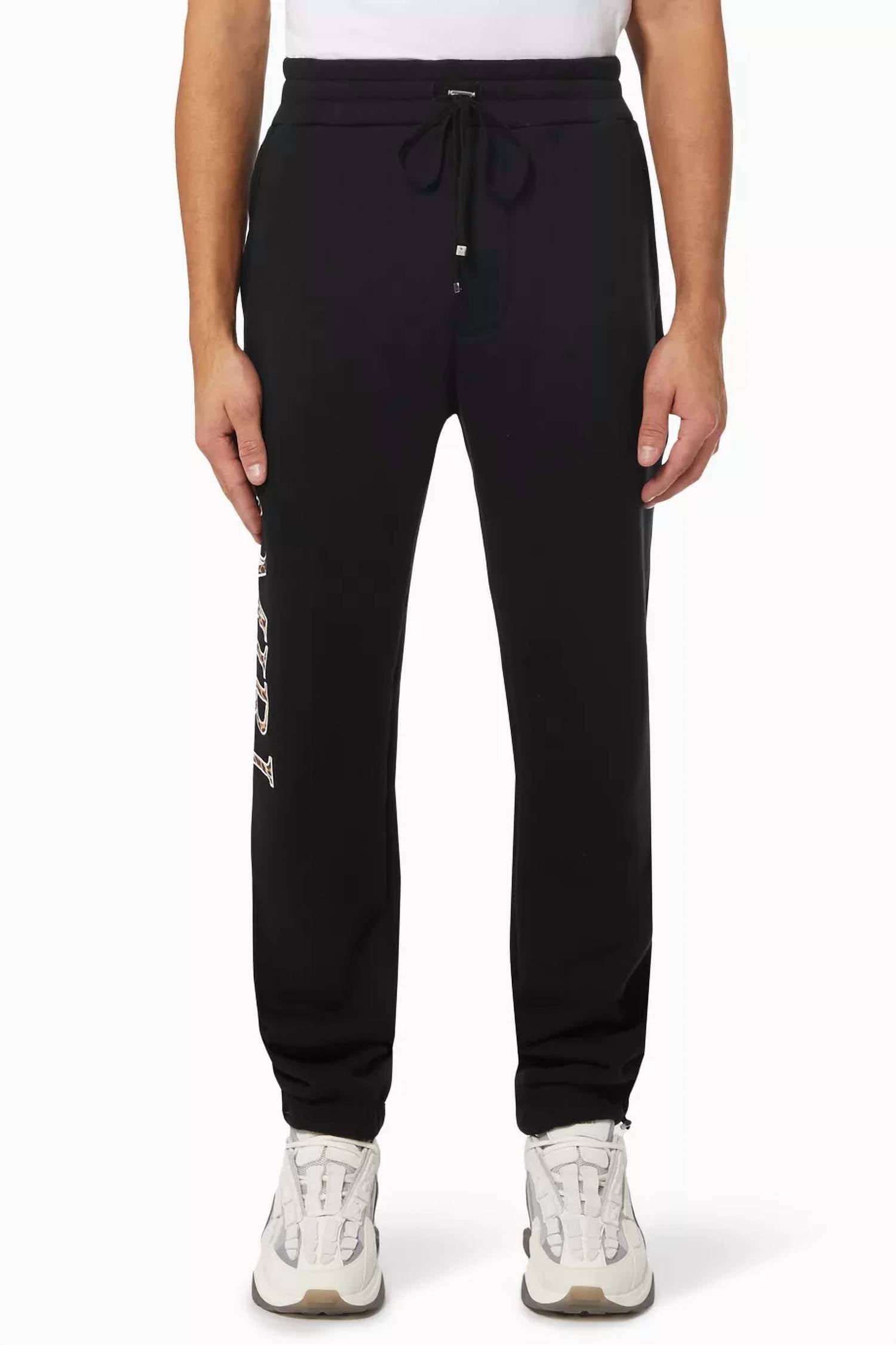 Amiri Leopard Applique Sweatpants in black - men's pants