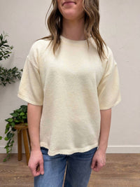 AEMI + CO Short Sleeve Knit Sweater in cream - women's t-shirt - detail view