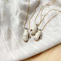 The Artifact House Women's Ceramic Hand Pendant Necklace in white and gold - women's jewelry - detail view