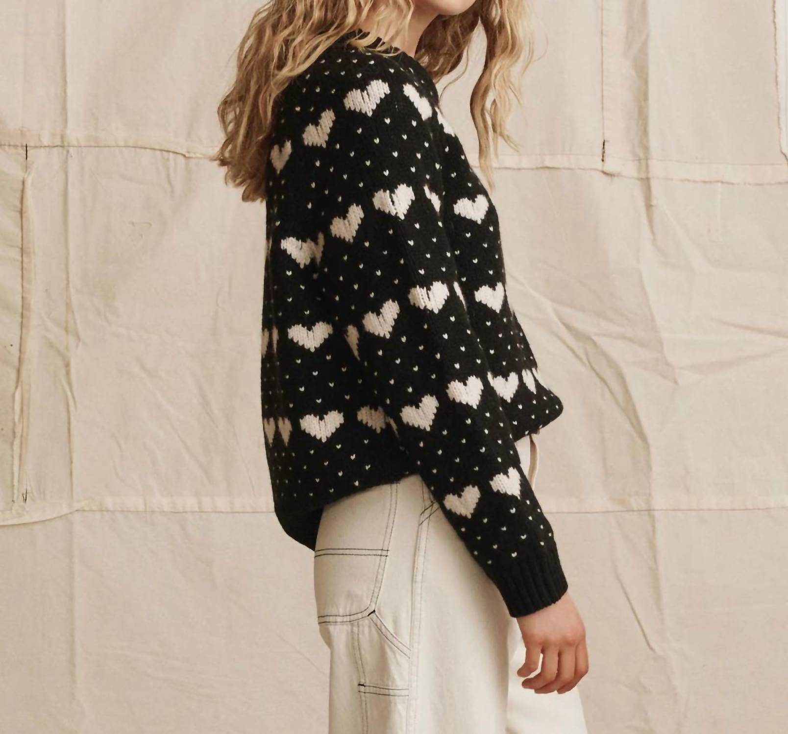 THE GREAT. The Heart Crew Sweater in black w pearl - women's sweater - detail view