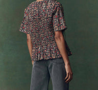 THE GREAT. Smocked Flounce Top in garland print - women's blouse - detail view