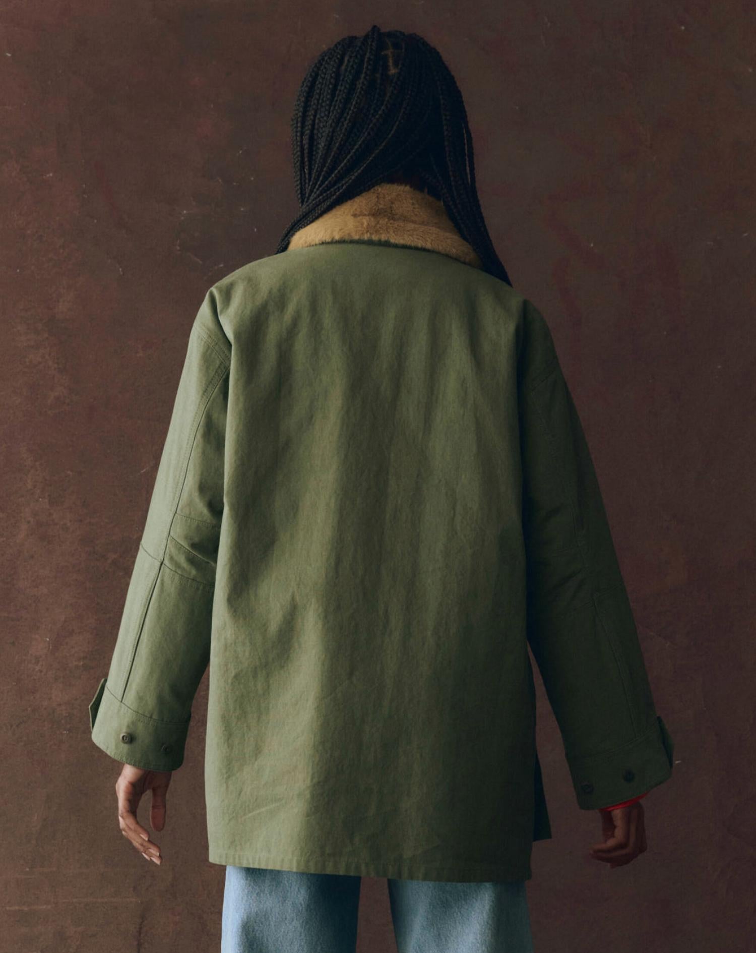 THE GREAT. Reversible Quilted Liner Parka Jacket in army hot orange - women's jacket - detail view