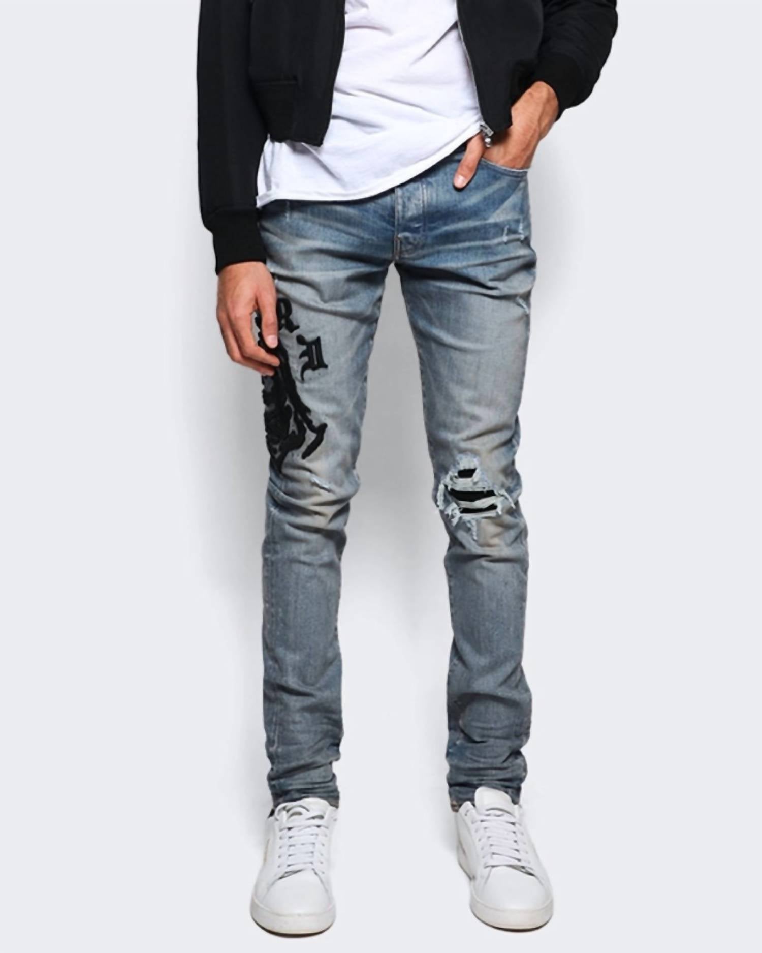 Amiri Wes Lang Reaper Logo Jeans in clay indigo - men's jeans