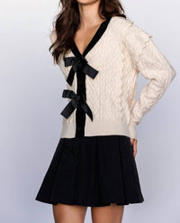 Storia - CABLE KNIT CARDIGAN WITH BOWS
